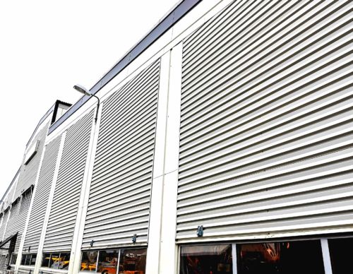 Outside of a factory with big white gates
