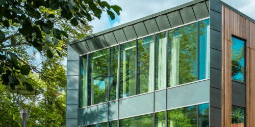Cropped photo of a building with static solar control glass with sunny background