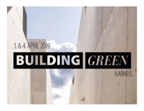 The text "Building Green Aarhus" in a black block over a background of grey buildings