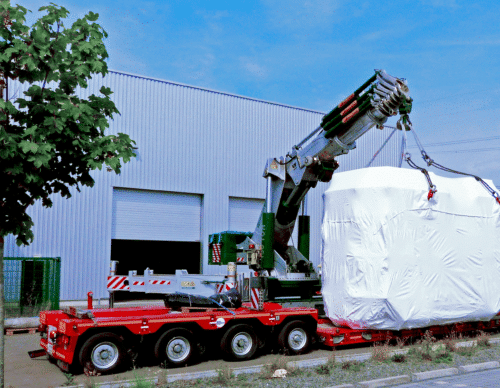 Sputter machines are being delivered to ChromoGenics on a red trailer.