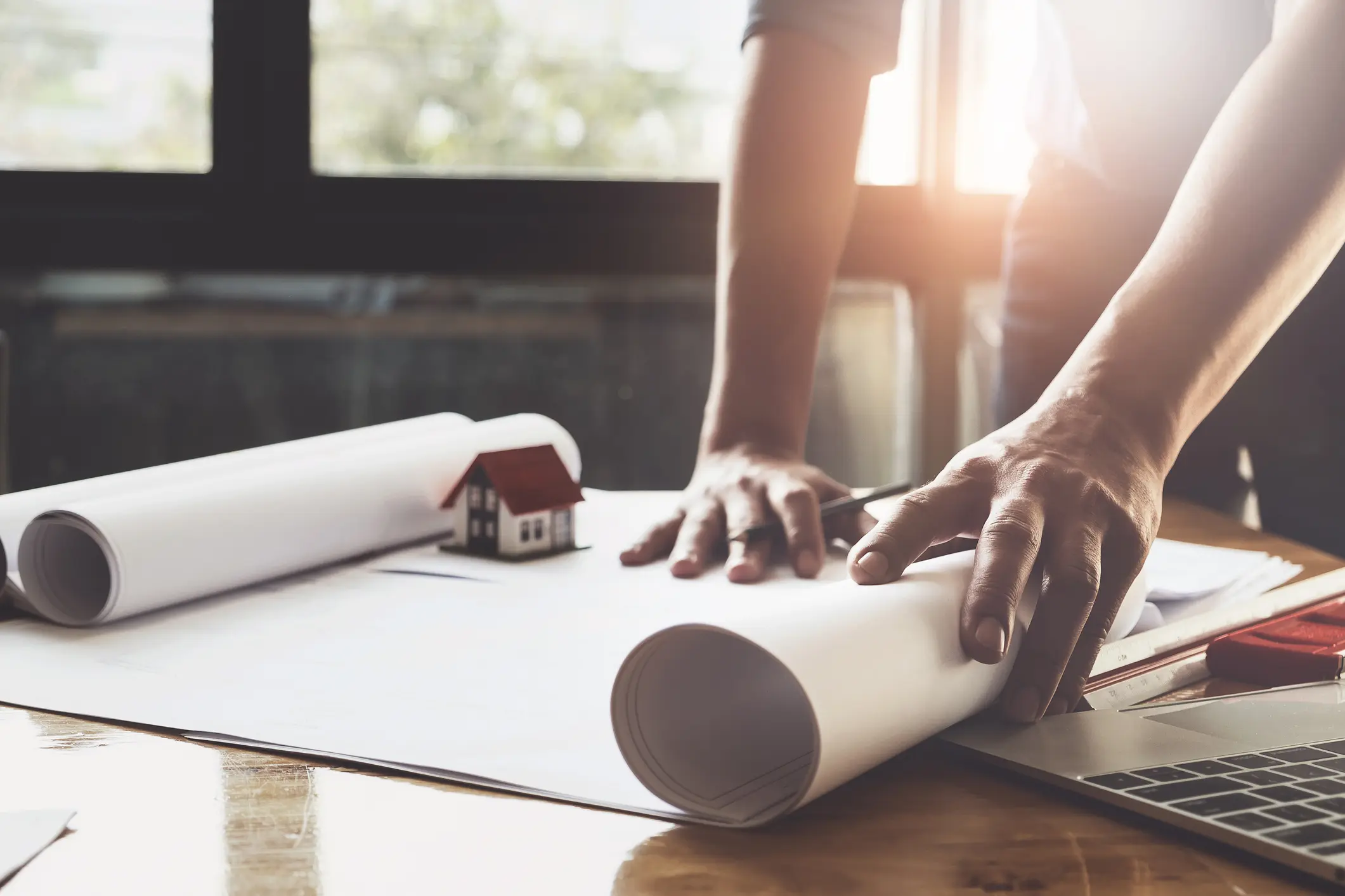 Architect man working with compasses and blueprints for architectural plan,engineer sketching a construction project concept. Architect man working with compasses and blueprints for architectural plan.